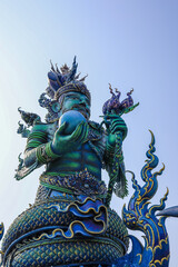 Fototapeta premium Chiang Rai Province,Northern Thailand on January 19,2020:Angellic Temple Guardians at the entrance pillars of Wat Rong Suea Ten or Blue Temple.