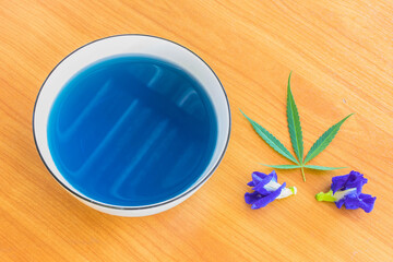 Cannabis ,Marijuana and  Blue Pea, herb hot tea on the bowl with  Cannabis leaf and  Blue Pea flower.