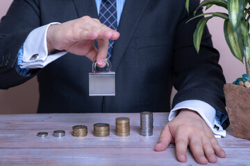 man with padlock in hand protecting money