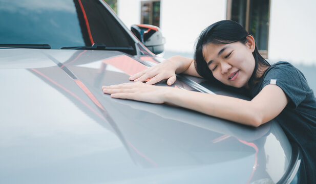 Happy young asian woman buyer new car.