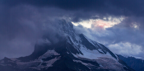 Fototapeta na wymiar Beautiful evening light and storm cloudscape in the Swiss Alps