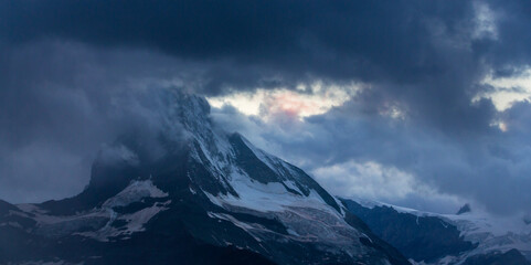 Fototapeta na wymiar Beautiful evening light and storm cloudscape in the Swiss Alps