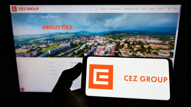 Stuttgart, Germany - 02-06-2022: Person holding smartphone with logo of Czech energy company CEZ a.s. on screen in front of website. Focus on phone display.