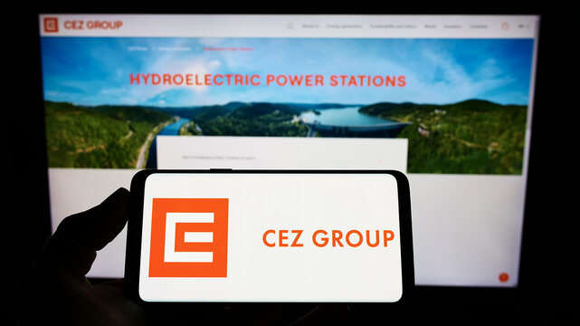 Stuttgart, Germany - 02-06-2022: Person holding mobile phone with logo of Czech energy company CEZ a.s. on screen in front of business web page. Focus on phone display.