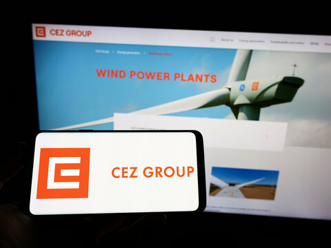 Stuttgart, Germany - 02-06-2022: Person holding cellphone with logo of Czech energy company CEZ a.s. on screen in front of business webpage. Focus on phone display.