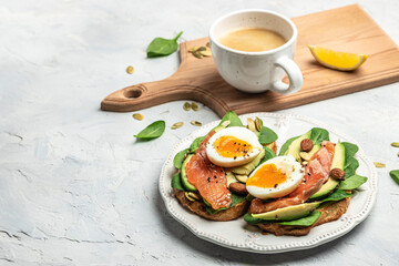 Delicious breakfast or snack whole grain bread with avocado paste and salmon. keto paleo diet. banner, menu, recipe place for text, top view