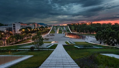 Tableaux ronds sur aluminium brossé Budapest Budapest, Hungary - Illuminated rooftop garden of the Museum of Ethnography at City Park with dark clouds and colorful sky at sunset