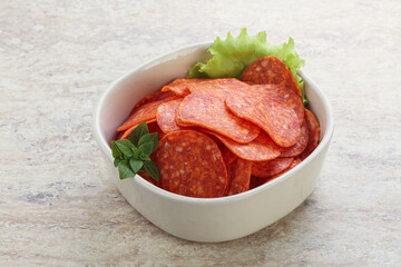 Sliced pepperoni sausage in the bowl