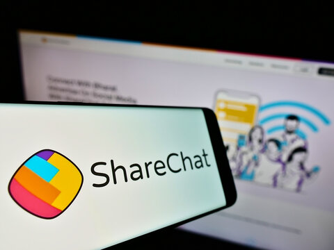 Stuttgart, Germany - 02-11-2022: Smartphone with logo of Indian company Mohalla Tech Pvt Ltd (ShareChat) on screen in front of website. Focus on center-left of phone display.
