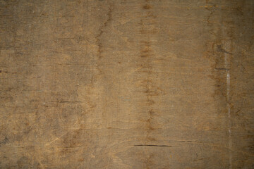 Background texture of a yellow or gold wooden table surface.