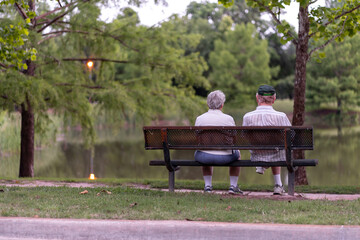 couple sitting on bench by water