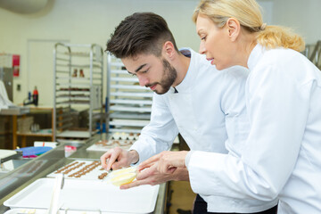 portrait of workers preparing chocolate