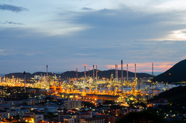 Fototapeta na wymiar Oil refinery plant chemical factory and power plant with many storage tanks and pipelines at sunset.
