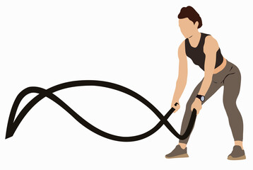 Girl training with battle rope in crossfit gym. Battle ropes session.