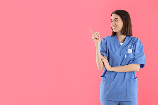 Concept of profession, young female doctor on pink background
