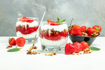 Parfait with yogurt, granola, jam, fresh berries and mint leaves in glass jar. gluten free diet, Healthy breakfast. banner, menu, recipe place for text