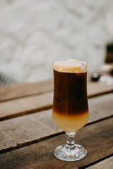 Iced yuzu orange espresso coffee mocktail cold brew tonic spritz on wooden background, Concept menu for coffee shop.