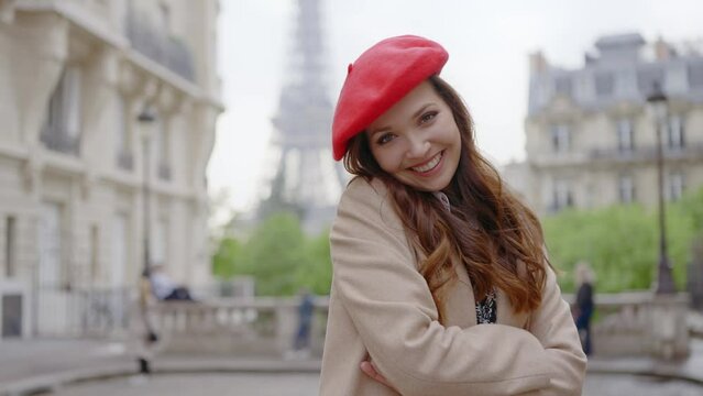 Cinematic footage of a young woman wearing fashionable clothes having fun in Paris at the eiffel tower park and  streets. Concept about european tourism and travels to the capital cities