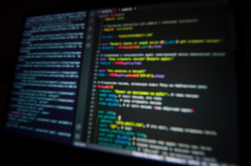 background: computer code on laptop screen in blur