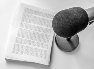 professional microphone and text on sheets of paper