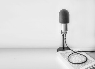 professional microphone and text on sheets of paper background