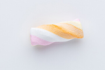 Colorful marshmallows on pastel background.