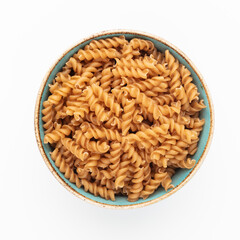 Whole fusilli pasta in a wooden bowl.