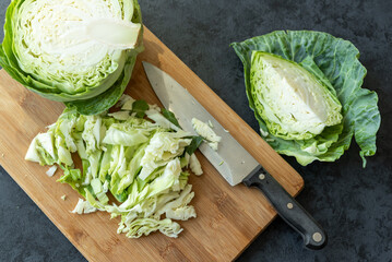 Chopped young fresh cabbage on a kitchen board