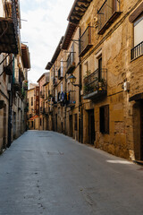 Fototapeta na wymiar Cobblestoned street in the medieval town of Laguardia, Alaba, Spain. Picturesque And Narrow Streets On A Sunny Day. Architecture, Art, History, Travel