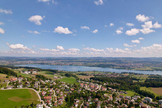 Scenic rural landscape with Lake Greifensee at Forch K&uuml;snacht with mountain panorama in the background on a sunny summer day. Photo taken June 12th, 2022, Forch K&uuml;snacht, Switzerland.