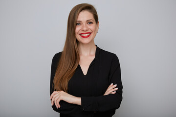 Smiling business woman in black shirt standing with arms crossed, isolated female portrait. - 512925068