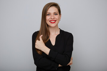 Obraz premium Smiling business woman in black showing thumb up, isolated female portrait.