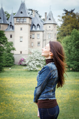 Young woman on the background of the castle in Goluchow, Poland.