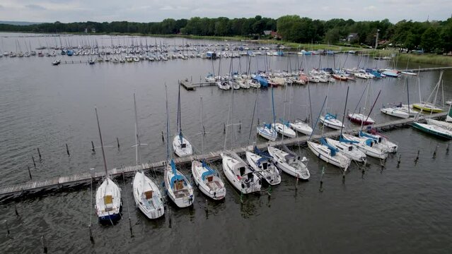 Sailboat harbor on an overcast day. Drone footage of boats in the water.