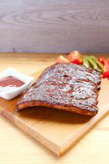 Closeup of Mouthwatering BBQ Pork Ribs with Grilled on a Cutting Board