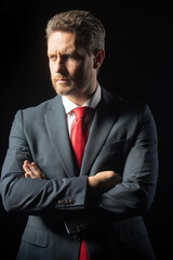 Studio portrait of serious businessman wearing suit and tie and looking thoughtfully. Face of business man. People, business, fashion and clothing concept, closeup of man in suit and necktie.