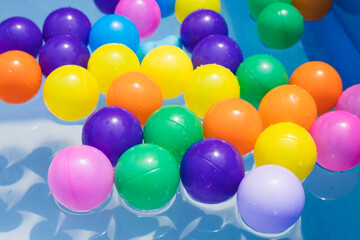 Fototapeta na wymiar Colorful balls. holiday, children's party, a games room, a box filled with small colored balls. Many colorful plastic balls in a swimming pool.