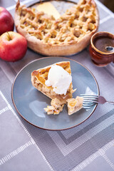Piece of Fresh homemade Traditional Apple Pie with ice cream on a domestic kitchen