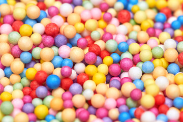 Small multicolored polyfoam balls, theme of holidays and birthdays. - obrazy, fototapety, plakaty
