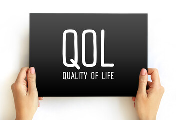 QOL Quality of life - degree to which an individual is healthy, comfortable, and able to participate in or enjoy life events, acronym concept on card - obrazy, fototapety, plakaty