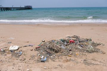 Trash water bottles pollution on beach (Environment concept)