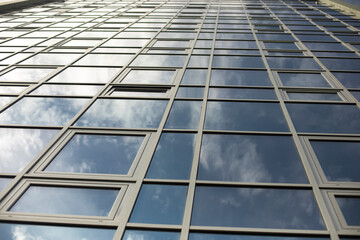 Building is made of glass. Mirror surface in office building.