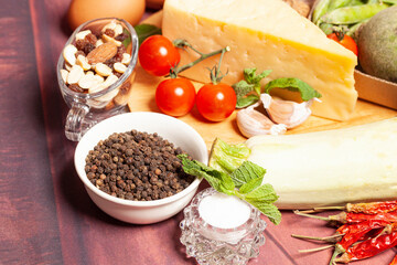 Vegetables and cheese on a wooden background.