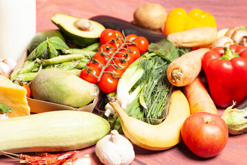Healthy food selection with fruits,vegetables,cheese,nuts, milk,spices, on wooden background