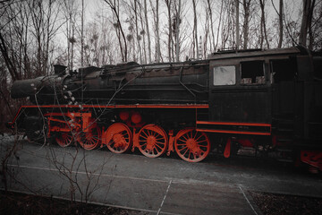 Steam locomotive parked at a terminal station. Historical railroad from 1940