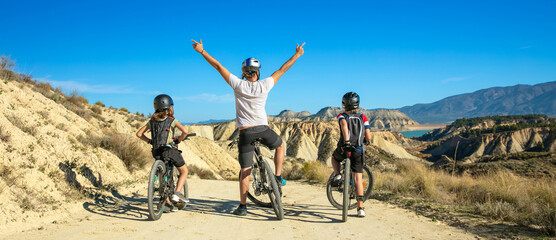 happy family on mountain bike in Andalusia - obrazy, fototapety, plakaty