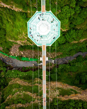 Dashbashi, Georgia - 19th june, 2022: Aerial top down view Diamond shape platform on glass bridge over scenic dashbashi valley in Georgia countryside. Famous modern bridge over valley in caucasus