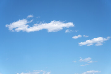 There are thin white clouds hanging on the blue sky