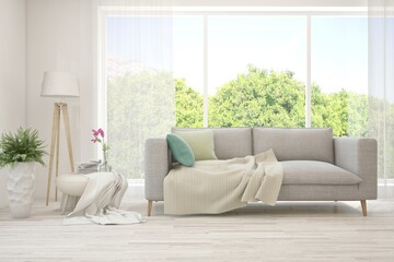 White living room with sofa and summer landscape in window. Scandinavian interior design. 3D illustration