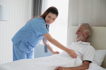 Professional caregiver taking care of elderly woman at home